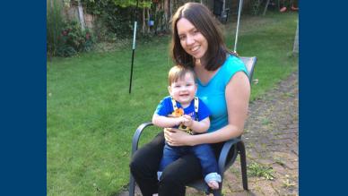 Fee sitting in her garden with her baby