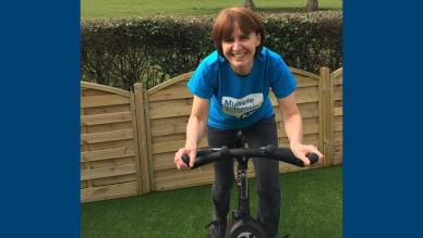Rowena on an exercise bike in her garden