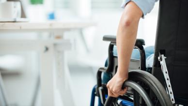 Young man's hand on wheelchair
