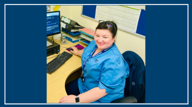 Image or AMSC Rachel sitting at her desk wearing her uniform