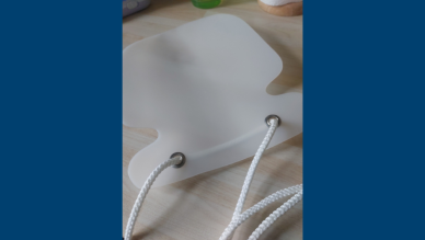 Piece of plastic with rope coming through it