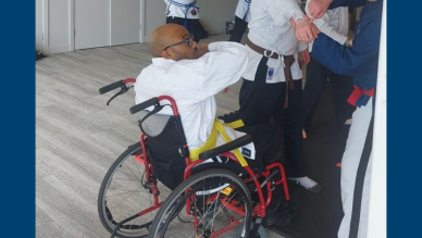 Christopher blocking an opponents attack in wheelchair jiu-jitsu