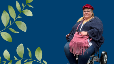 Antoinette in a powered wheelchair next to leaves.