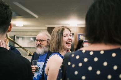 A woman laughing.