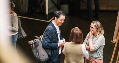 A group of three people in conversation.