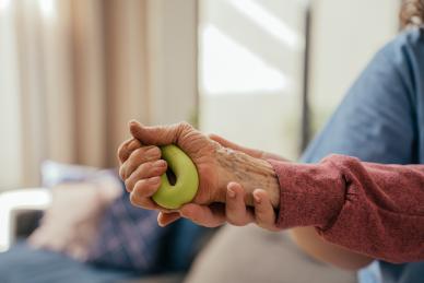 A hand trying to squeeze a ball