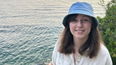 lady with brown short hair and a blue bucket hat