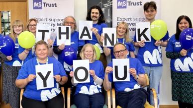MS staff holding thank you sign