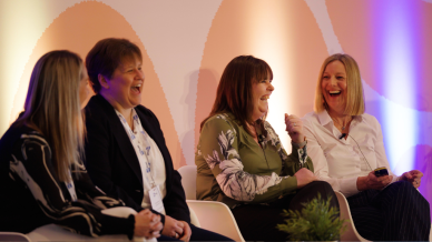 Speakers sitting and laughing at MS Trust conference