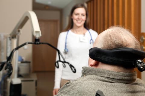 Image of man with MS talking to a health professional