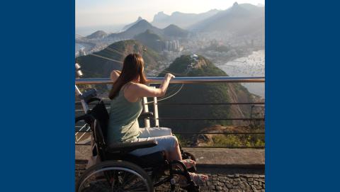 Lady in wheelchair looking at Brazil cityscape