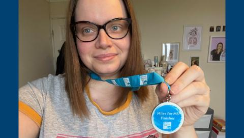 Sam holding her 'Miles for MS finisher' medal