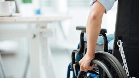 Young man's hand on wheelchair