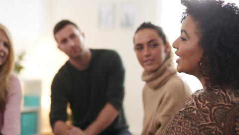 Woman speaking at focus group meeting