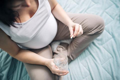 Pregnant woman taking pills