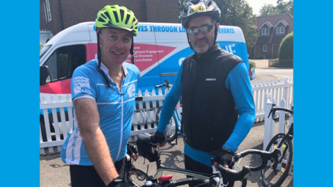 Image of David Martin with cycling helmet and MS Trust jersey, with friend next to him.
