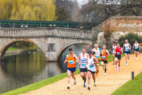 runners going past the River Cam