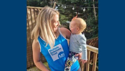 Olivia holding her baby in the garden