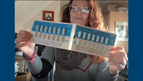 Helena holding up her Tecfidera medication