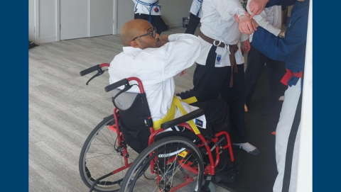 Christopher blocking an opponents attack in wheelchair jiu-jitsu