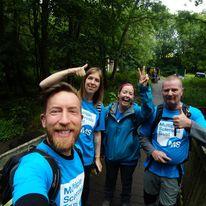 image of four people in MS Trust T Shirts taking a selfie whilst out on a walk