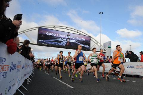 runners racing off from the start line of the Manchester Marathon