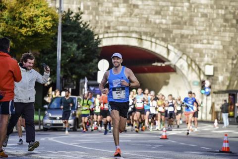 man running the Porto Marathon in an MS Trust vest top