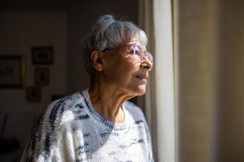 senior woman looking out window