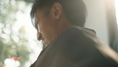 Man grimaces in pain