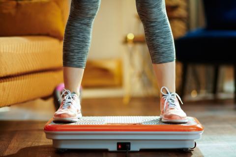 Person standing on vibration plate