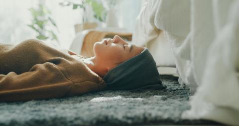 Woman laying on the floor eyes closed