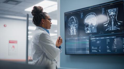 Female neurologist looking at MRI scan