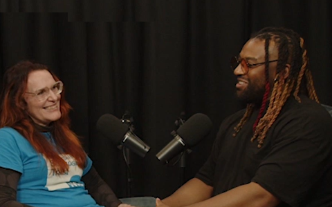 Two people talking in a podcast studio
