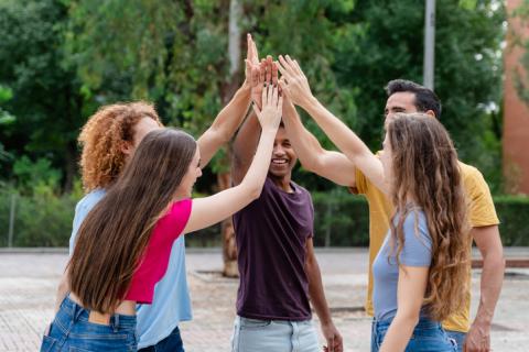 group with their hands in their air for a high-five