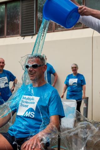 Man being gunged in MS Trust t shirt