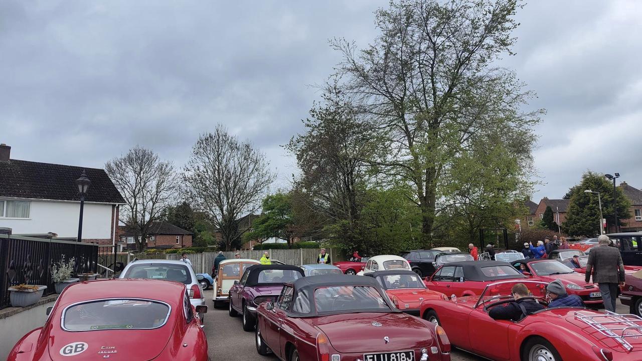 car park full of red classic cars
