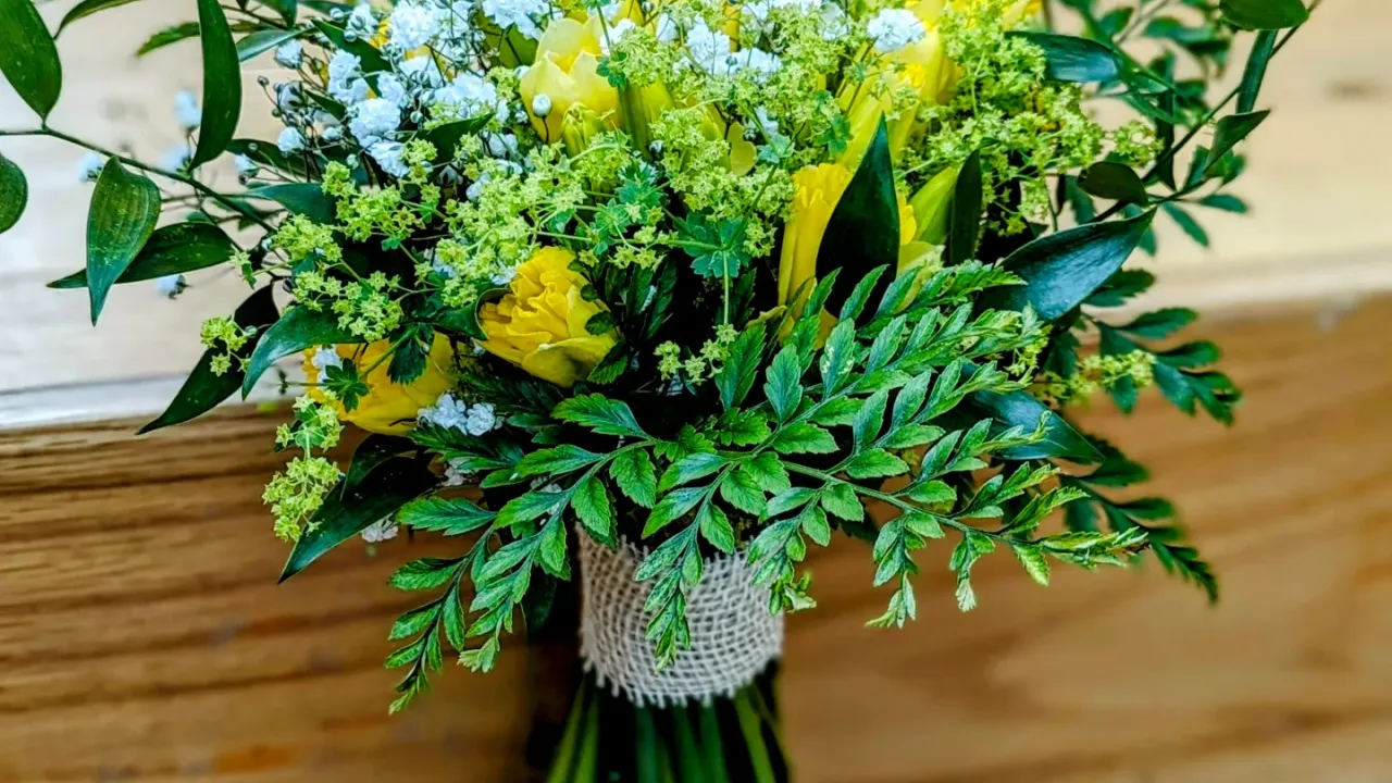 Bouquet of Daffodils, baby's breath and various leaves. Wrapped with a hessian ribbon