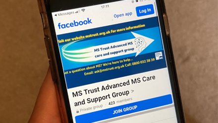 Someone looking at the MS Trust Advanced MS Care and Support Group on their phone